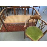 An Edwardian inlaid mahogany sofa, on turned legs and a similar corner chair