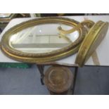 An early 20th century gilt oval wall mirror together with a reproduction gold painted wall shelf and