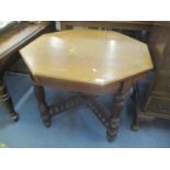 A late Victorian walnut octagonal topped occasional table having gadrooned columns and united