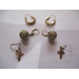 A 9ct pair of gold crucifix earrings, a pair of yellow metal ball shaped earrings (total weight of