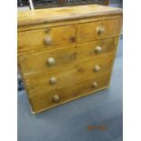 A Victorian pine chest of two short and three long graduating drawers having bun handles