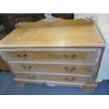 A pine lime washed chest of three long drawers on bracket feet