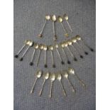 A set of twelve silver bean spoons A/F together with ten other mixed silver teaspoons, total