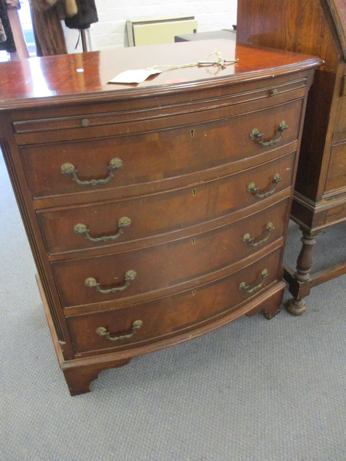 A reproduction mahogany bow fronted chest of four graduated drawers