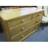 An early 20th century pine chest of two short and two long drawers having bun shaped handles 74 x