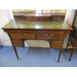 An Edwardian mahogany inlaid ladies desk with raised back, green leather scriber and tapering