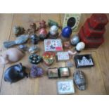 A quantity of decorative ornaments to include onyx eggs, stone boxes, painted paper-mache items, a