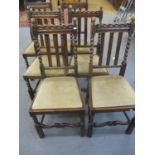A set of six oak dining chairs having outer barley twist spindles