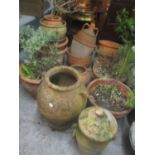 A selection of garden terracotta planters to include a twin handled vase formed example and others