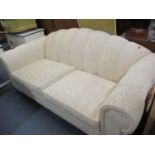 A modern cream chenille style sofa having a scalloped back 192cm wide x 94cm deep