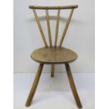 A late 18th/early 19th century Welsh primitive chair, with ash stick back, an elm slab seat, resting