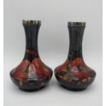 A pair of Walter Moorcroft small vases in the Pomegranate pattern, with silver plated mounts to
