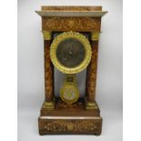 A late 19th century French rosewood portico clock having a silvered dial with Roman numerals and