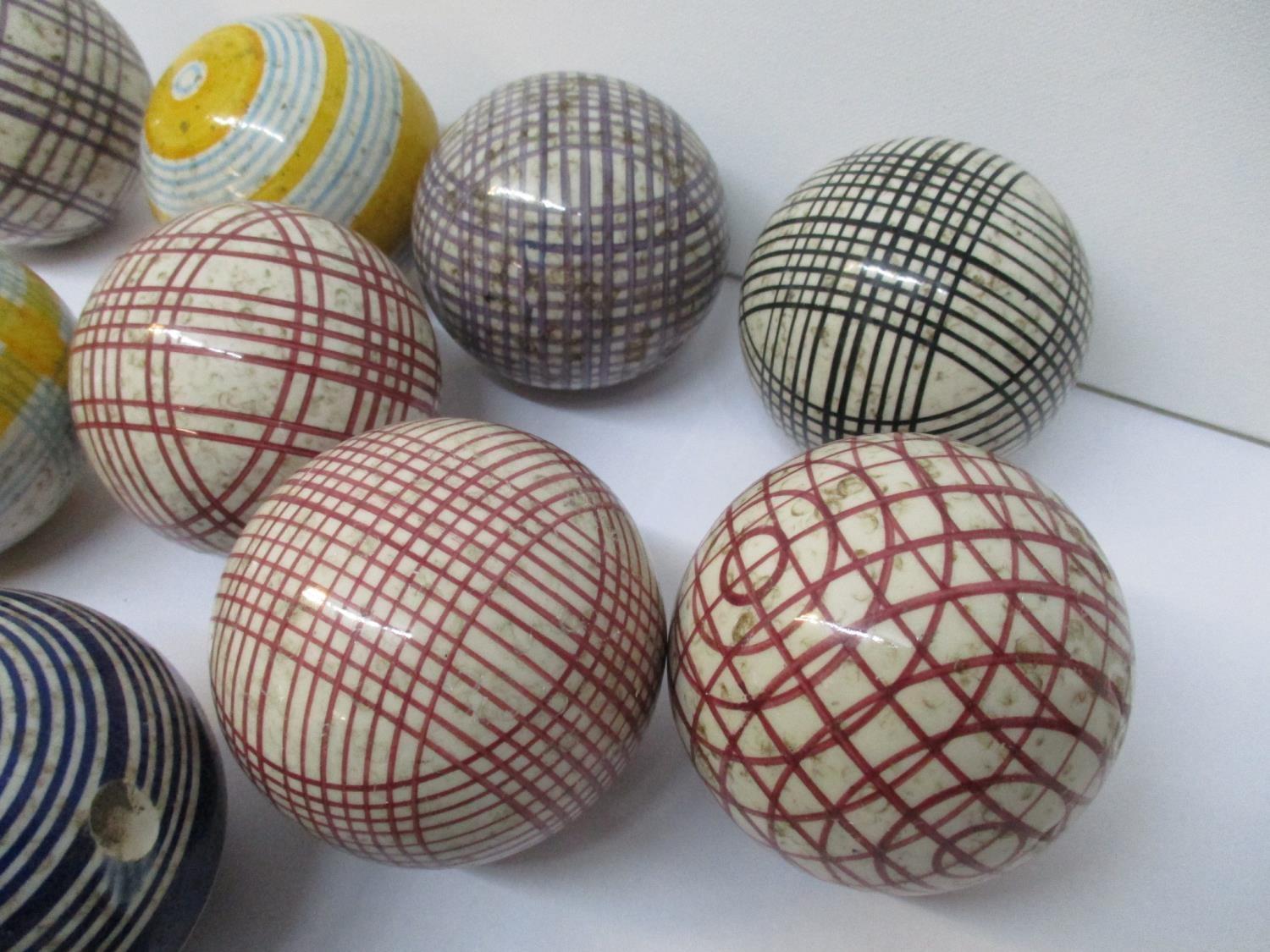 A group of thirteen Victorian Scottish ceramic carpet bowls, with colourful tartan and striped - Image 4 of 4