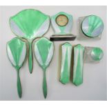 An Art Deco eight piece silver and enamel dressing table set, of which five pieces are by James