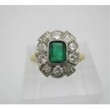An 18ct gold diamond and emerald cluster engagement ring, with central emerald cut emerald