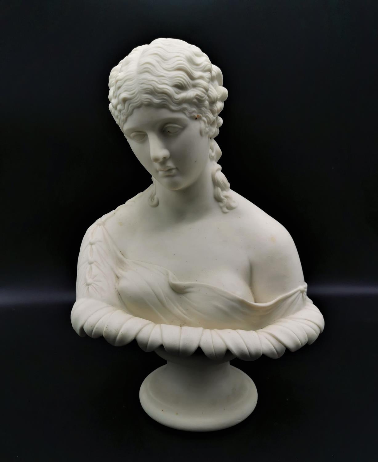 A turn of the century parian ware Neoclassical bust of Clytie, probably by Copeland, on a short