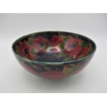 A large William Moorcroft bowl in the pomegranate pattern, raised on a small circular base, with