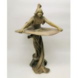 A 20th century Art Nouveau style sculpture, modelled as a maiden with draped clothing holding a