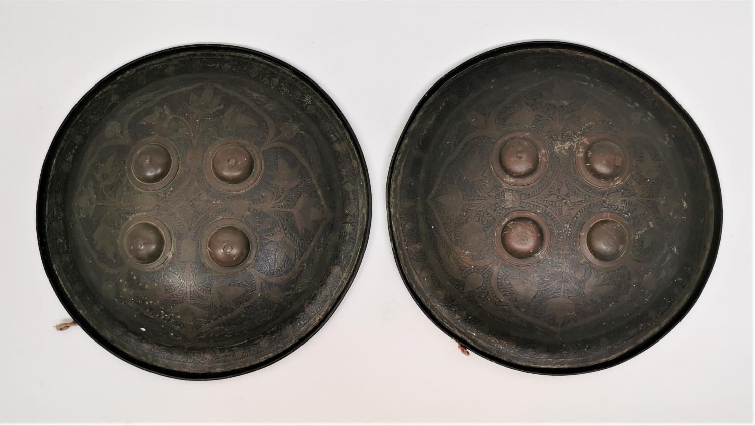 A pair of small Persian Qajar shields, of circular form designed with four domed bosses and