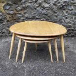 A nest of Ercol blonde elm and beech pebble tables, model 354, tallest one 40 cm high x 65 cm