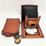 A Thornton-Pickard mahogany cased field camera, with brass fittings, three plates, unmarked brass