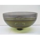 A Mid century Continental glass punch bowl, with thin black striped border and smoky body, signed