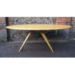 A Modern Design light oak dining table by Benchmark Furniture, of oblong form supported on four
