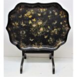 A Victorian tilt-top black lacquer tray top table, the serpentine outlined tray with gilt and