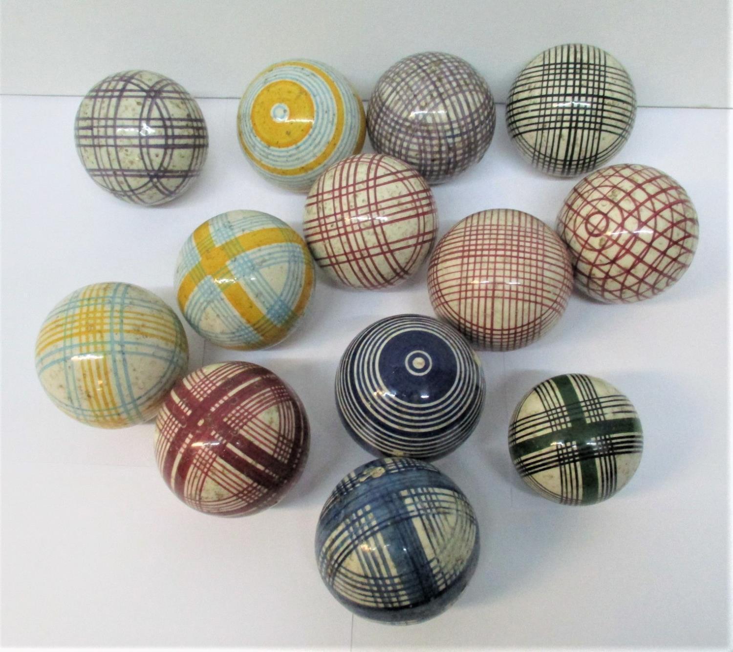 A group of thirteen Victorian Scottish ceramic carpet bowls, with colourful tartan and striped