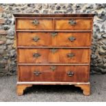 A mid 18th century walnut and pine sided chest of two short and three long drawers with crossbanding