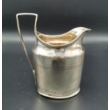A George III silver milk jug, London 1809, partial maker's initials '?L', with bright cut decoration