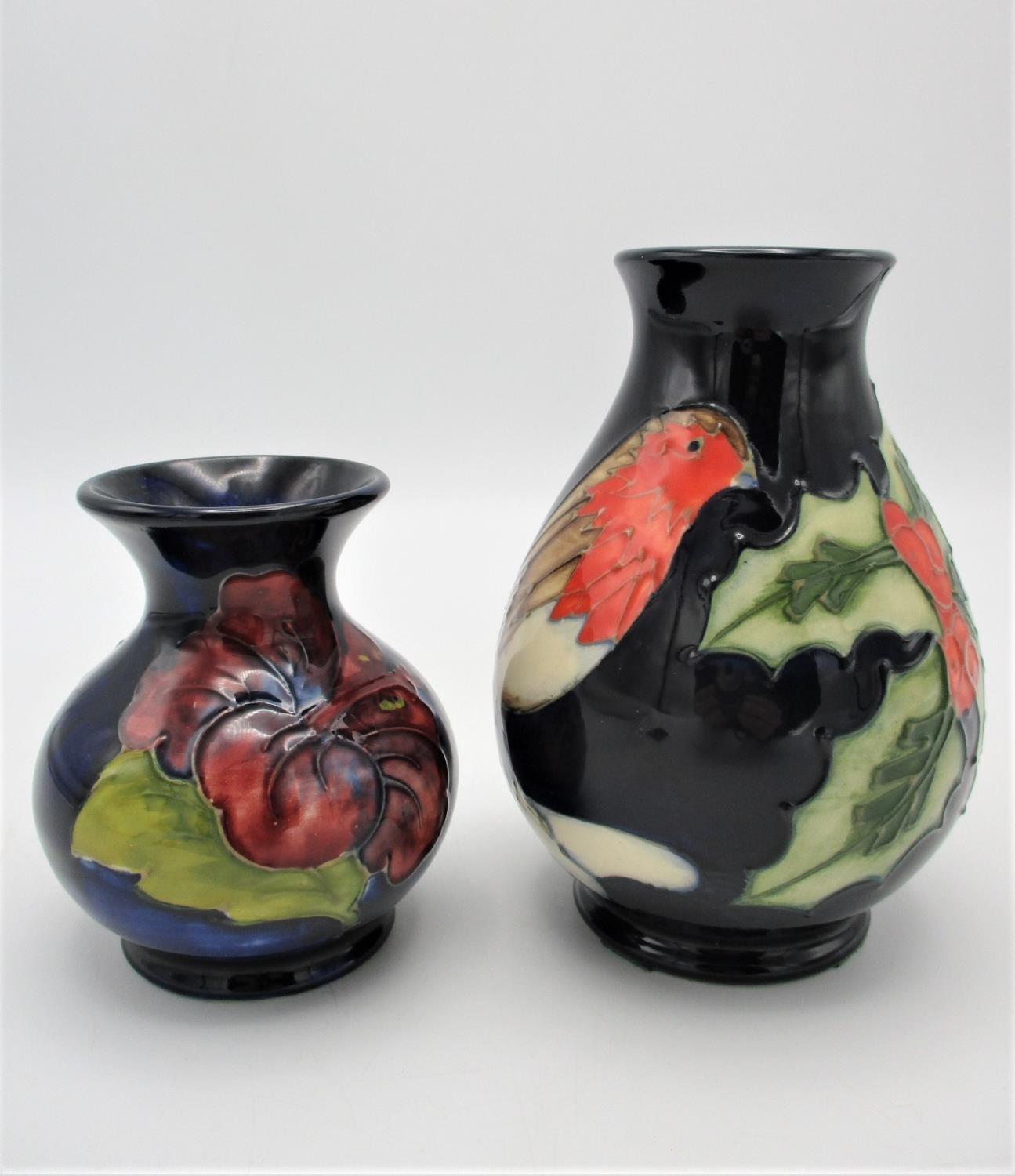 A Moorcroft squat baluster vase in the Hibiscus pattern, on deep blue ground, with impressed mark to