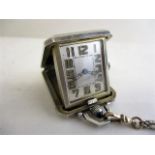 An Edison Watch Company silver travellers pocket watch with an engine turned, spring loaded, snap