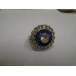 A daisy flower head dress ring set with white and blue paste stones UK ring size K