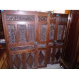 A group of four Anglo Asian carved hardwood doors with brass handles, pierced floral carved