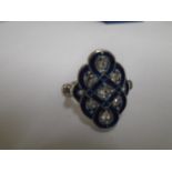 An Art Deco style plaque ring set with white paste stones and blue enamel, size I/J