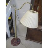 A brass standard lamp on a turned treen base