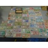 A quantity of various banknotes from around the world to include Mozambique, Japanese Ginko,