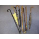 A mid to late 20th century selection of walking canes and umbrellas