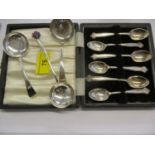 A 20th century silver tea strainer and matching caddy spoon, together with a Chinese silver spoon