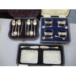 A cased set of four silver cruets with original spoons, together with a cased set of silver