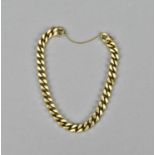 A 9ct gold curb link bracelet, with safety chain, 18 cm long, 27 g