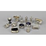 A small collection of miscellaneous silver condiment pots and other pieces to include a twin handled