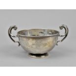 A George V silver twin handled pedestal bowl by David Munsey, London 1911, with scrolled handles