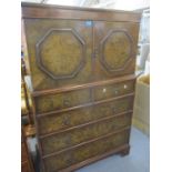 A 1930s quarter cut walnut veneered gentleman's tallboy Location: RAM