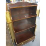 A reproduction mahogany waterfall bookcase with single drawer below 112cm h x 57cm w x 15cm d