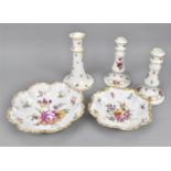 A small collection of German porcelain to include a pair of candlesticks, a Dresden bowl with hand