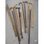 A silver topped walking cane, a silver plated topped walking cane and eight others, together with