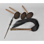 An African tribal art carved wooden hairpin, a fly swat with woven leather handle, and fabric and